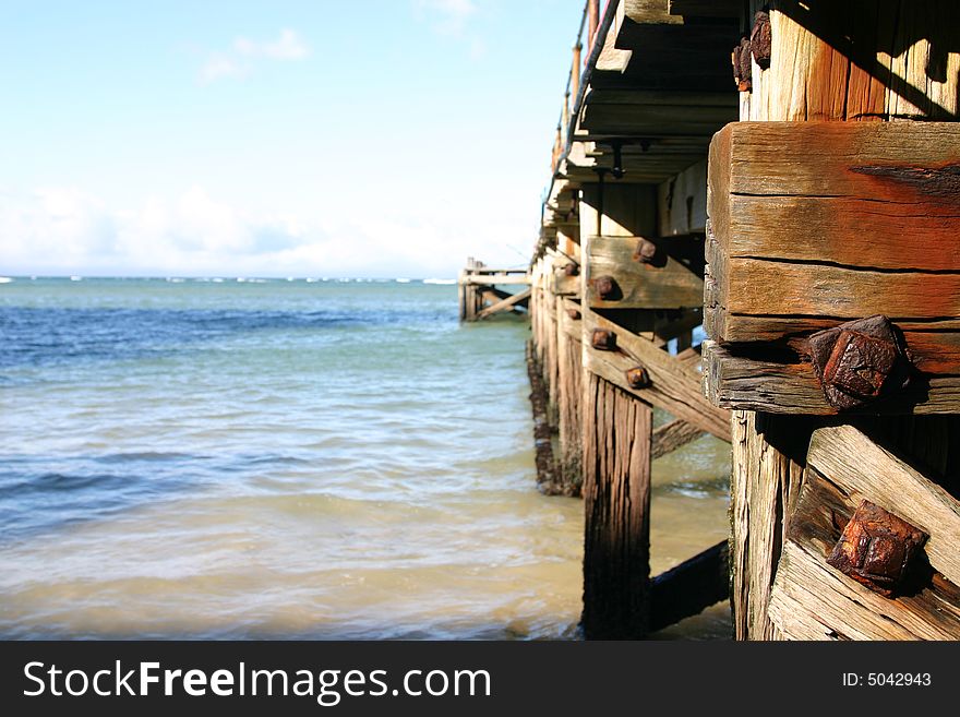 Old rusted ocean Pier at almost low tide