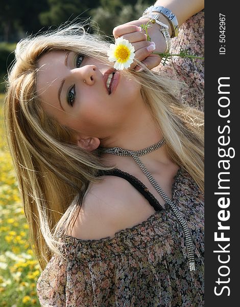 A blonde female model in a field full of daisies. A blonde female model in a field full of daisies