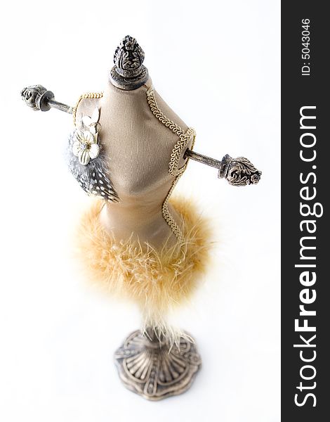 Wooden jewelry doll covered with material and feathers