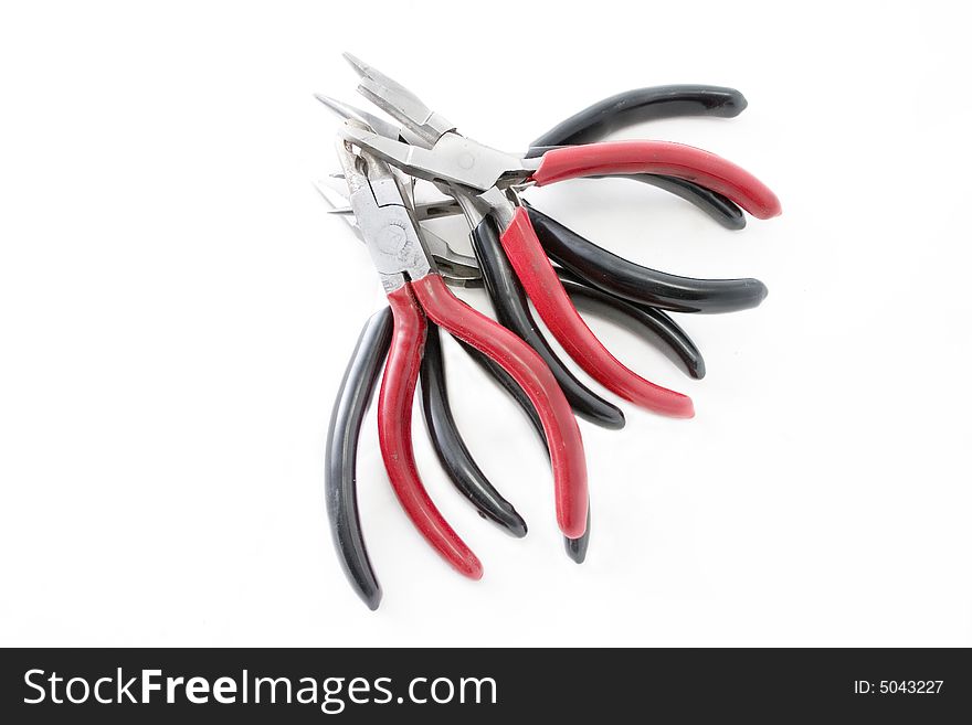 Pile of black and red steel pliers. Pile of black and red steel pliers