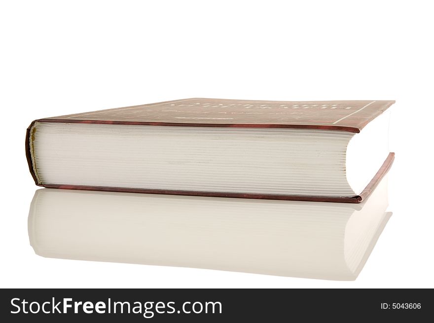 Isolated large closed book on a white background, selective focus