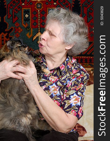 Grandmother talk with kitty on her hands