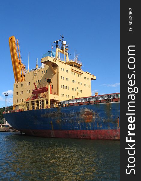 Docks in Swinoujscie - Poland. Large rusty ship is being repaired. Docks in Swinoujscie - Poland. Large rusty ship is being repaired.