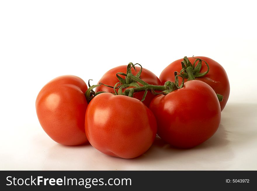 Group of tomatoes over white background