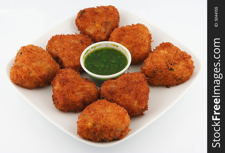 East indian  snack food garnished with green chillies. East indian  snack food garnished with green chillies