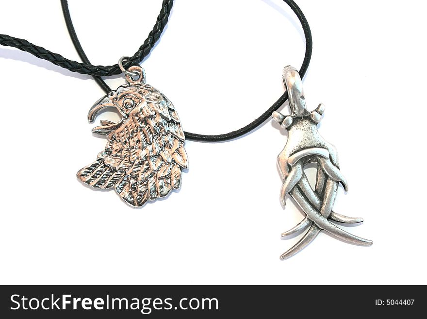 Two necklaces with cool medalions on the white.