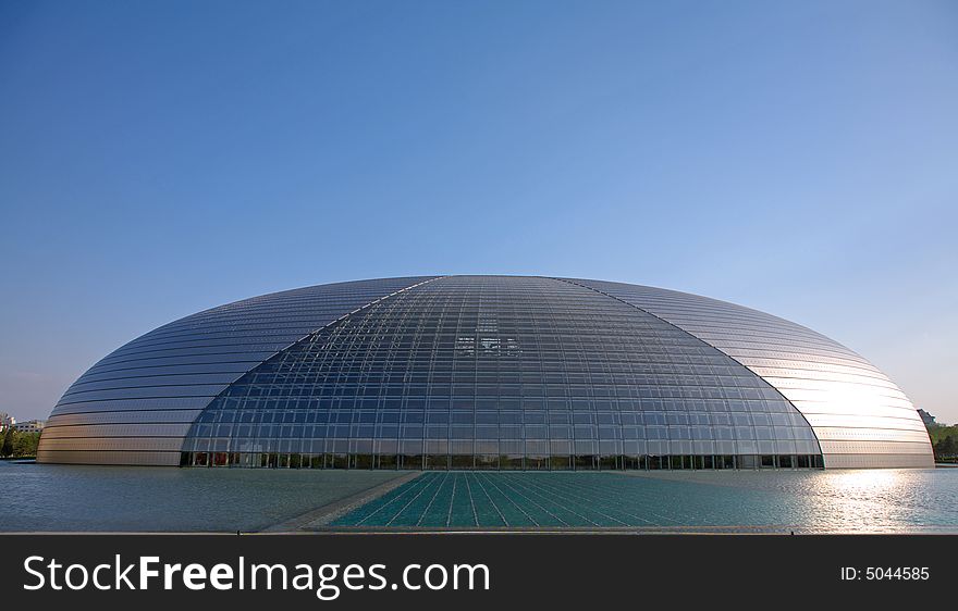 A modern theater building over the water.