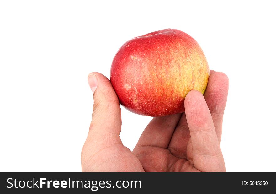 Red apple in the human hand on white