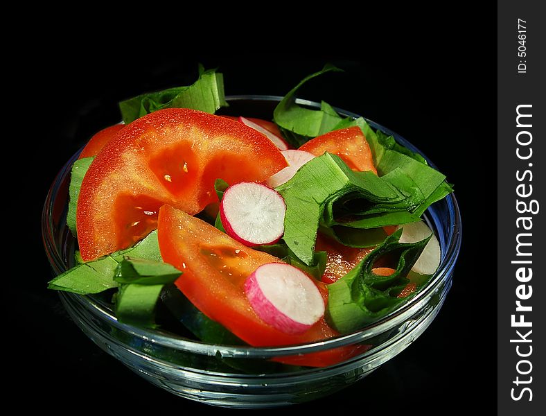 Spring salad from cucumbers, tomatoes and a garden radish. Spring salad from cucumbers, tomatoes and a garden radish
