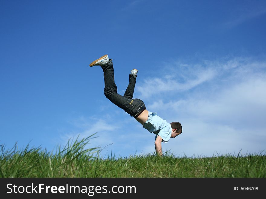 Young boy dancing on a grass. Young boy dancing on a grass