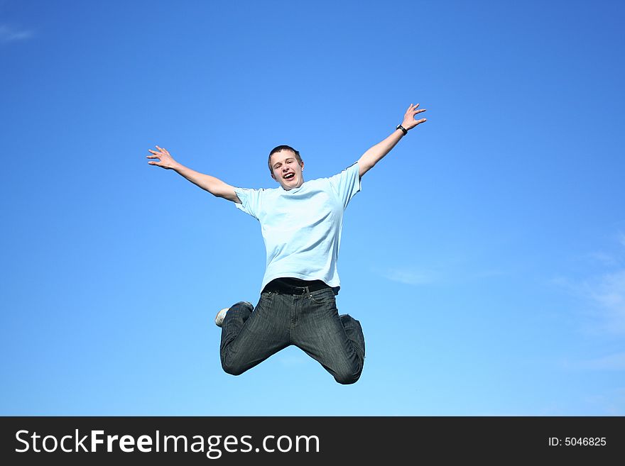 Young boy jumping on a sky background. Young boy jumping on a sky background