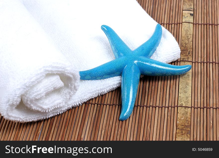 Colorful starfish on a white towel - spa and beauty. Colorful starfish on a white towel - spa and beauty.