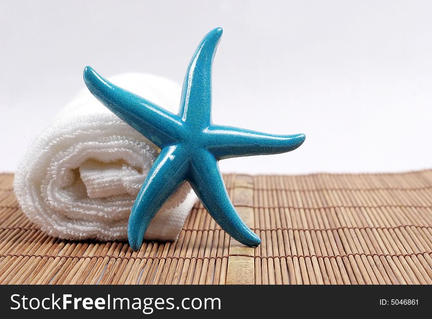 Colorful starfish on a white towel - spa and beauty. Colorful starfish on a white towel - spa and beauty.