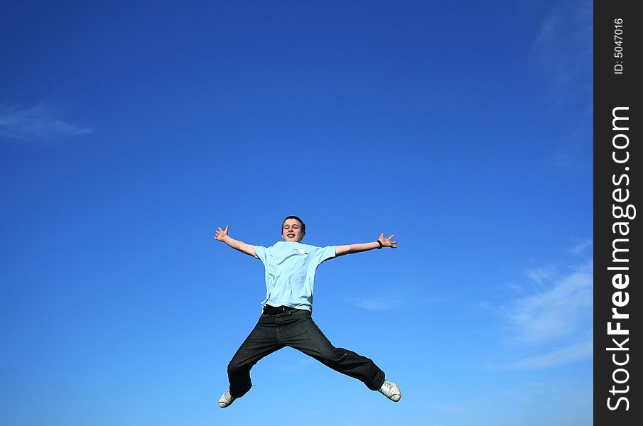 Young boy jumping on a sky background. Young boy jumping on a sky background