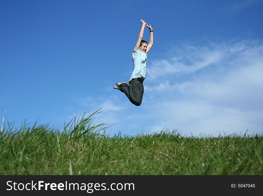 Young boy jumping on a sky background. Young boy jumping on a sky background