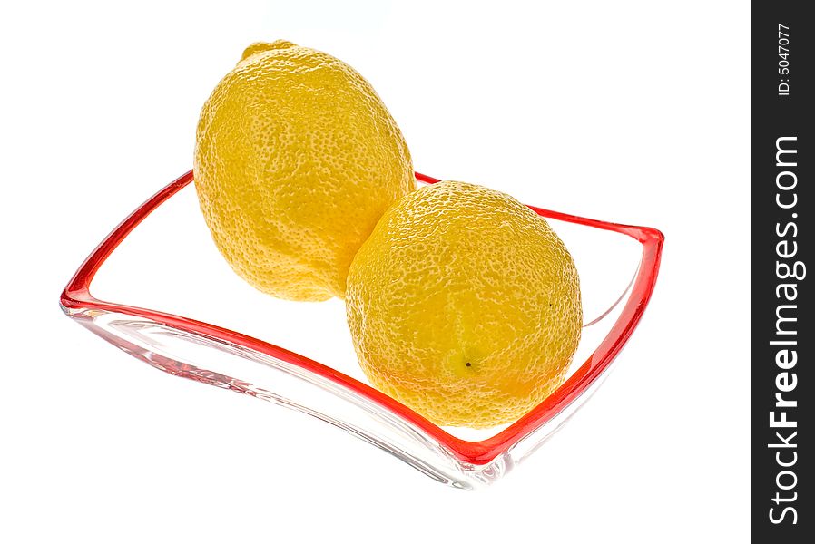 Two lemons on the glass saucer