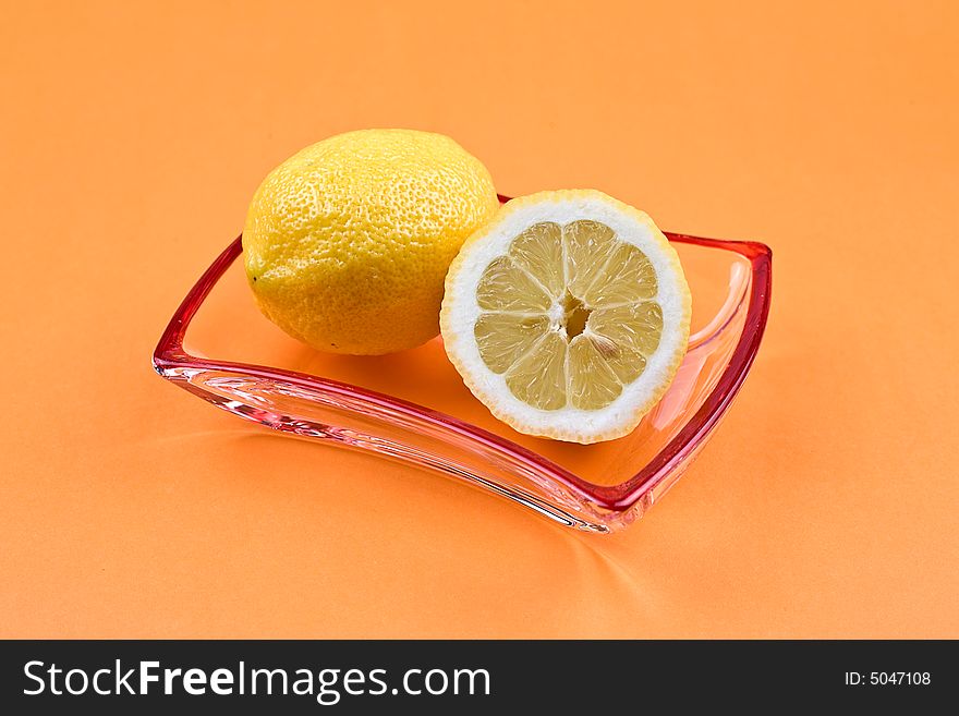 Two lemons on the glass saucer