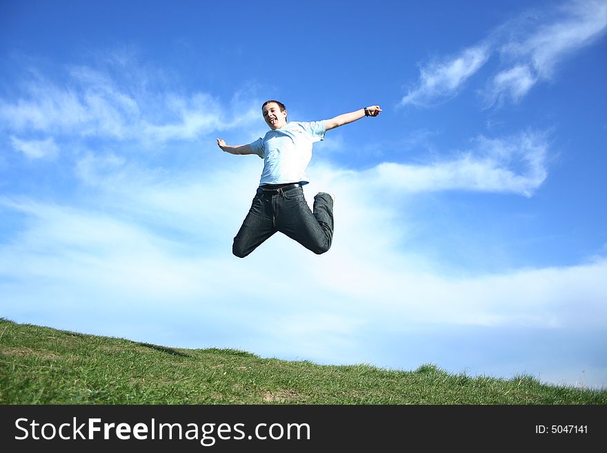 Young boy jumping on a sky background. Young boy jumping on a sky background