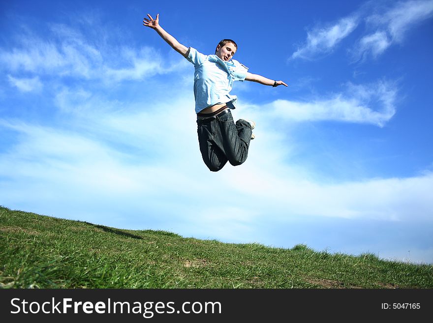 Young boy jumping on a sky background. Young boy jumping on a sky background