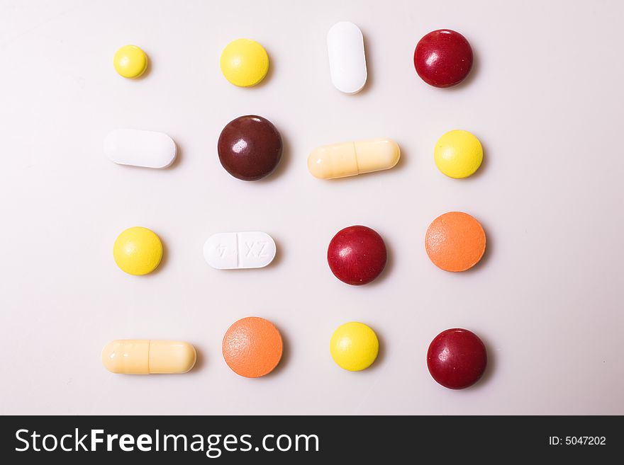Pills on white background; Shallow depth of field.