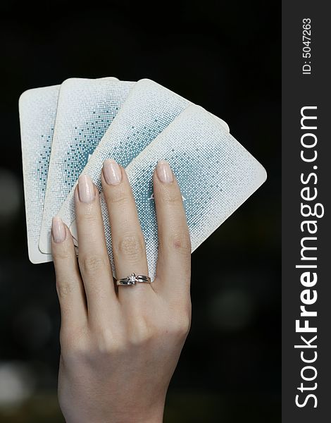 WomanÂ´s hand with four playing cards. WomanÂ´s hand with four playing cards