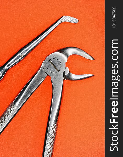 Stomatologic Tools On An Orange Background