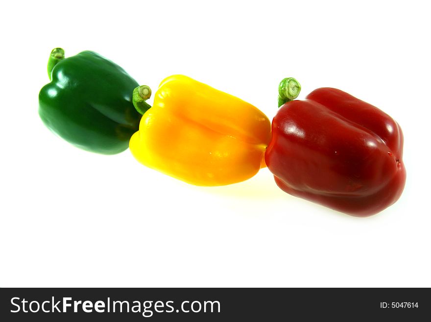 Isolated red, green and yellow paprikas