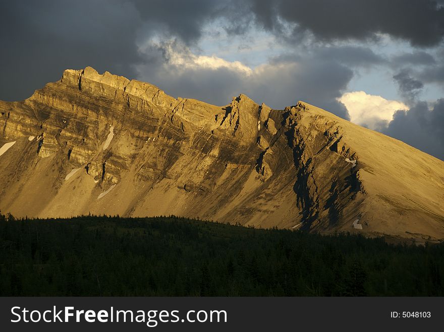 Evening light illuminates a remote mountain ridge. Evening light illuminates a remote mountain ridge