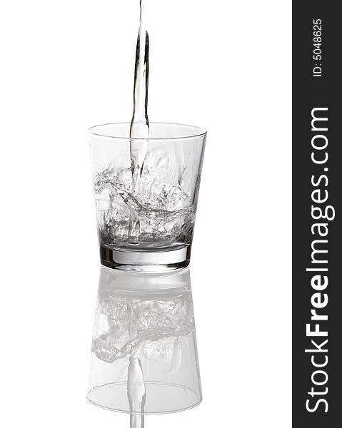 Water pouring into clear glass isolated on white background. Water pouring into clear glass isolated on white background