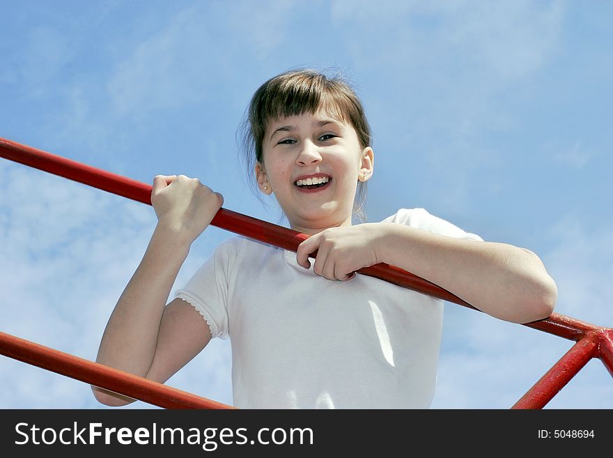 Smiling girl 11 years go up on sky background