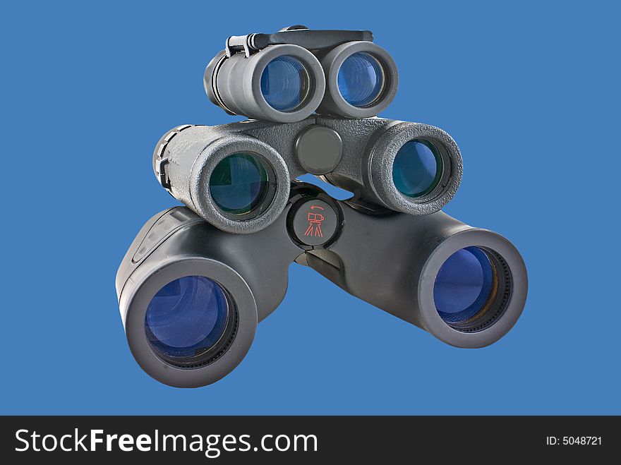 Binoculars of various sizes isolated on a blue background.