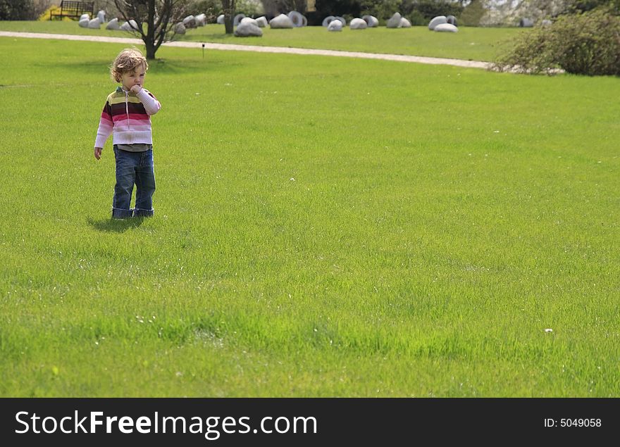 Child on the green lawn