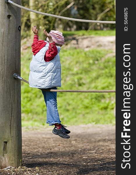 Little girl on an adventure playground. Little girl on an adventure playground