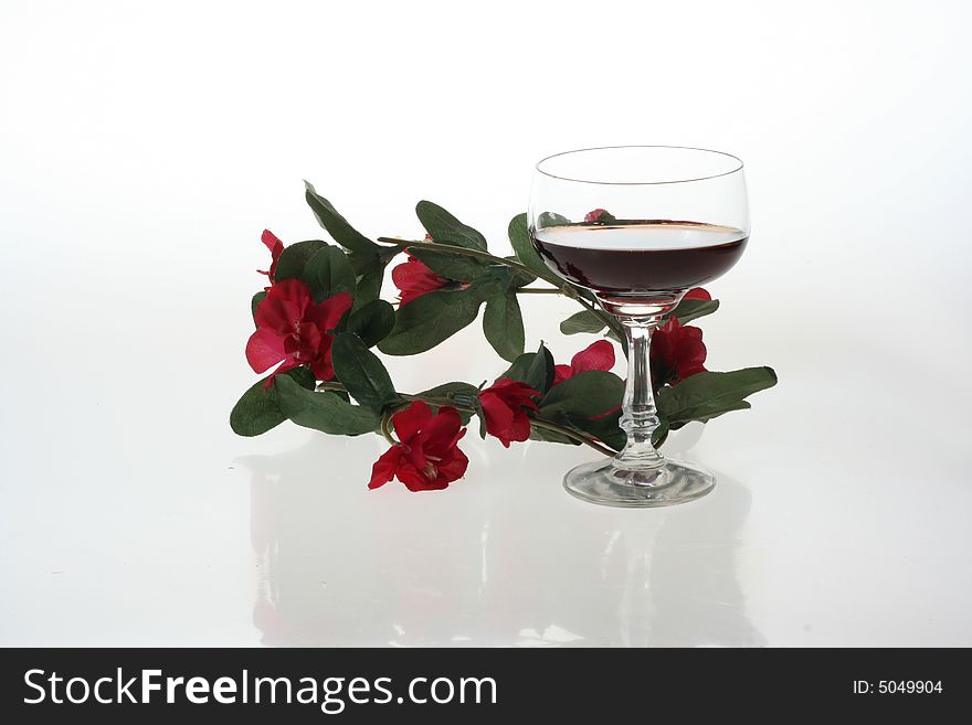 Wine glasses and red flowers. Wine glasses and red flowers