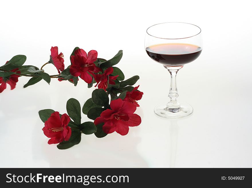 Wine glasses and red flowers. Wine glasses and red flowers