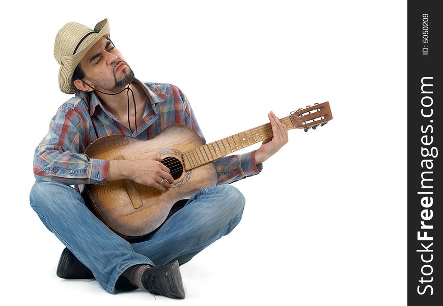 Man with hat and guitar sitting on floor and singing, isolated. Man with hat and guitar sitting on floor and singing, isolated