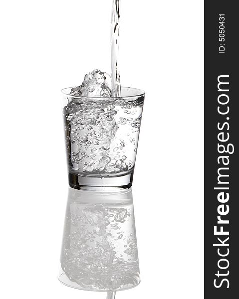 Water pouring into clear glass isolated on white background. Water pouring into clear glass isolated on white background