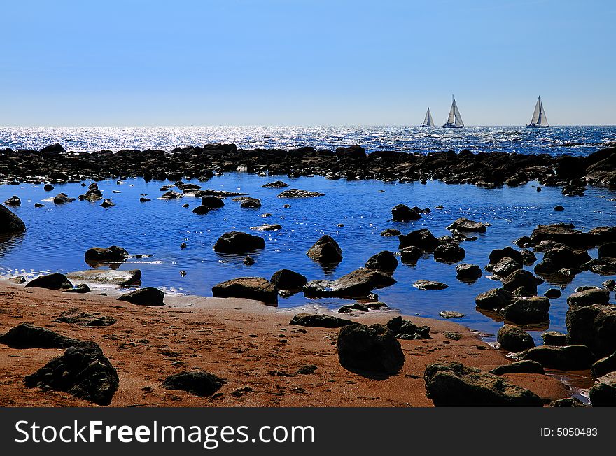 A picture like scene with some Boats , Rocks, and the sea. A picture like scene with some Boats , Rocks, and the sea...