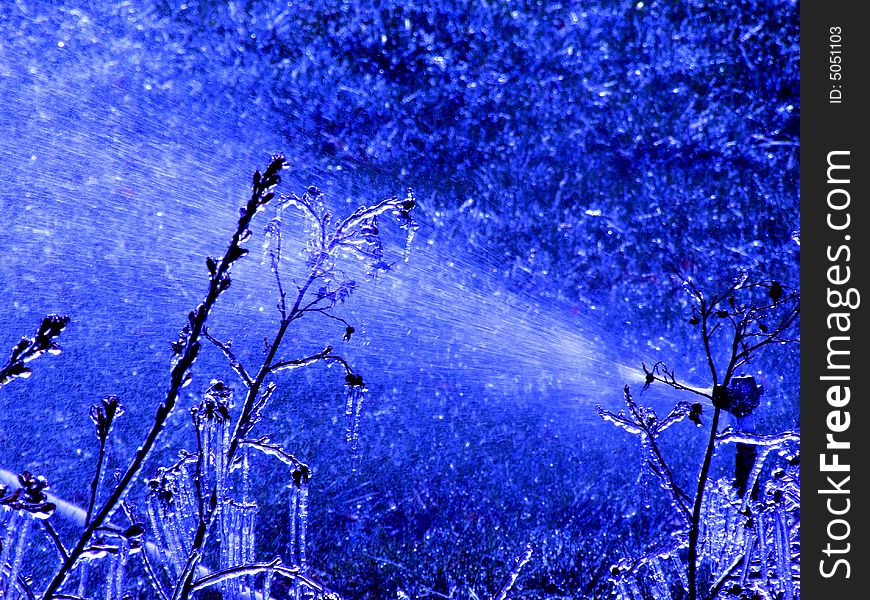 A Lawn Sprinkler left on over night creates frost and movement in the air. A Lawn Sprinkler left on over night creates frost and movement in the air.