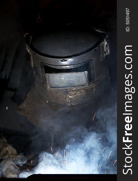 A welder working at shipyard at night. A welder working at shipyard at night