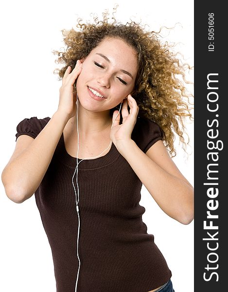 A beautiful young girl listening to music on her mp3 player. A beautiful young girl listening to music on her mp3 player