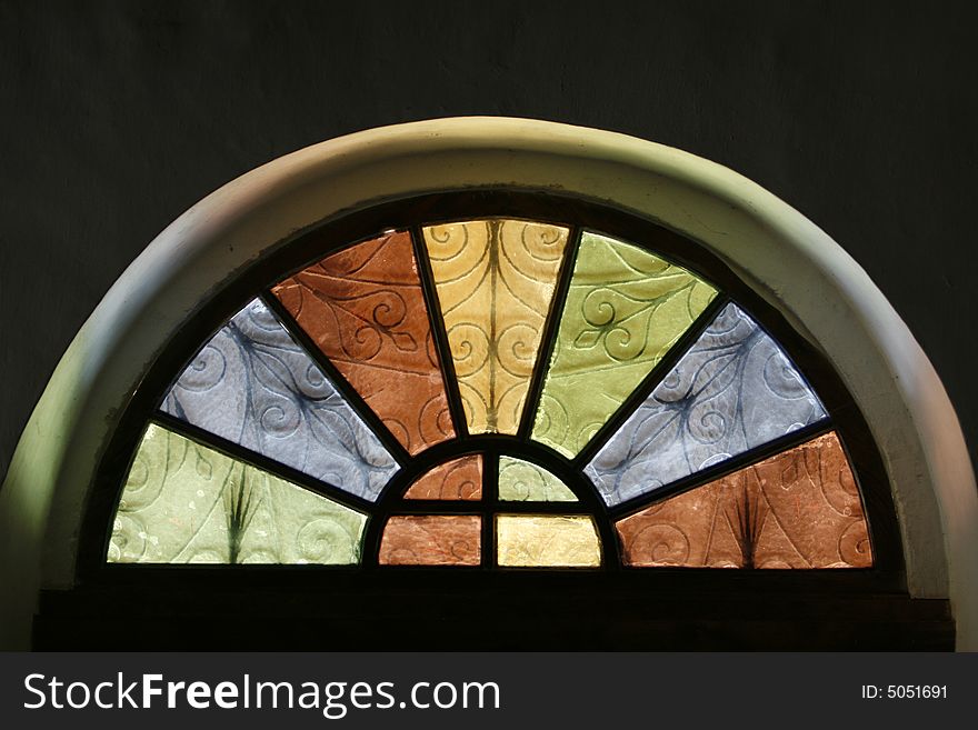 A window in a church with many colors. A window in a church with many colors
