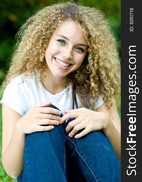 A young attractive girl sitting in the park