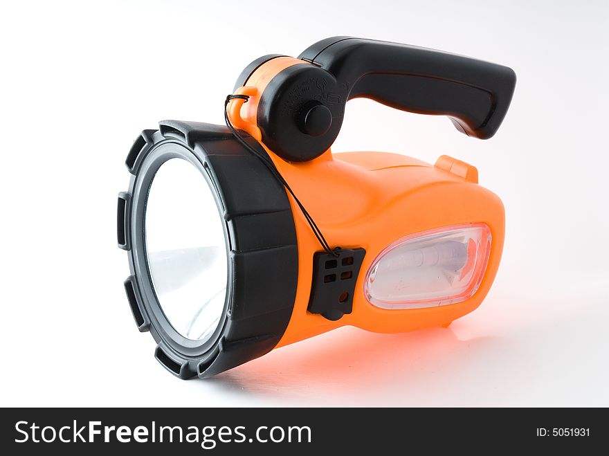 Isolated black orange high powered flashlight. Isolated black orange high powered flashlight