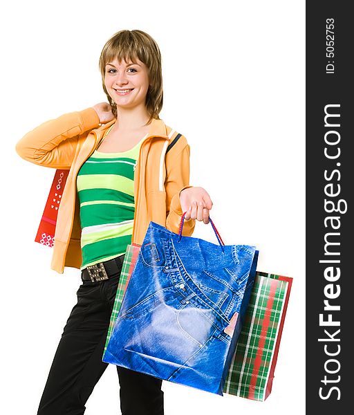 Pretty young woman holding bags on a white background. Pretty young woman holding bags on a white background