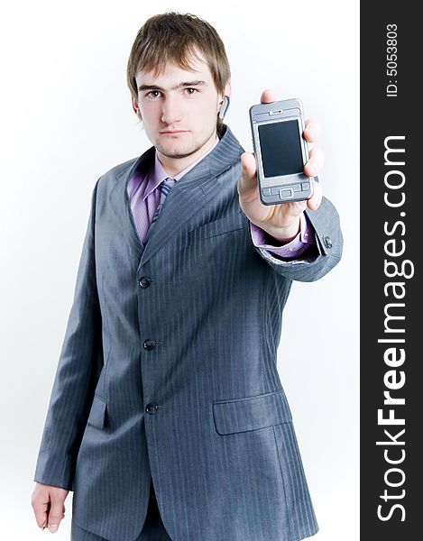 Businessman showing phone, focus on phone, isolated on white background