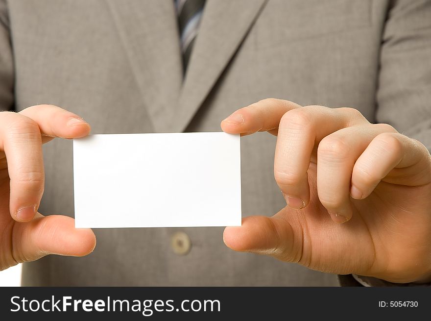 Blank business card in the hands of a businessman. Blank business card in the hands of a businessman