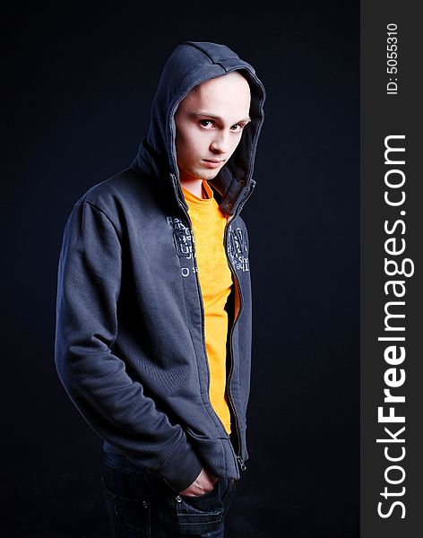 Fashion portrait of young man at black background. Fashion portrait of young man at black background