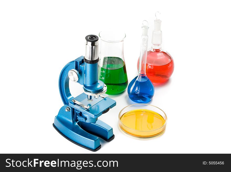 Various colorful flasks and blue microscope over white background