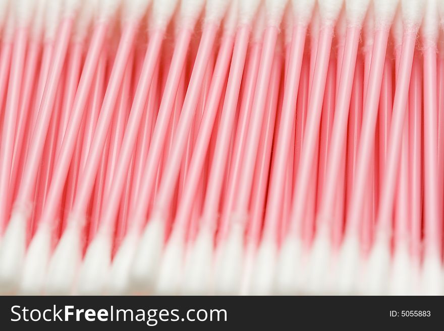 Line of cotton buds with pink plastic basis